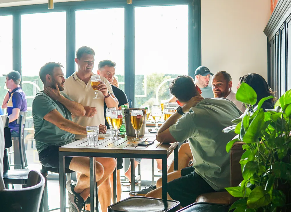 Friends with beers at Le Petit Belge Motor City